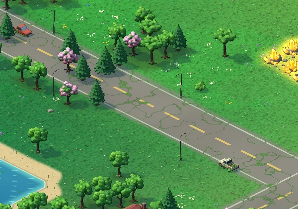 A cracked two-lane road running through meadow full of wildflowers, past quiet houses.